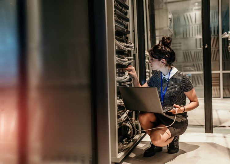 Female IT Engineer Working in Server Room