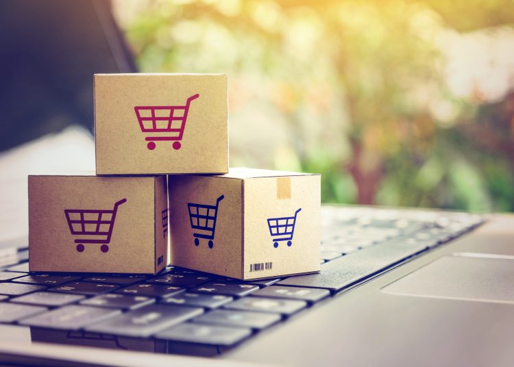 Online shopping / ecommerce and delivery service concept : Paper cartons with a shopping cart or trolley logo on a laptop keyboard, depicts customers order things from retailer sites via the internet.; Shutterstock ID 1023606736; Ordering Party: CMS CMNO (Hon Lam); Job/Project: 2004-0125524 - BROC - Internal CMS Master Issue tracker