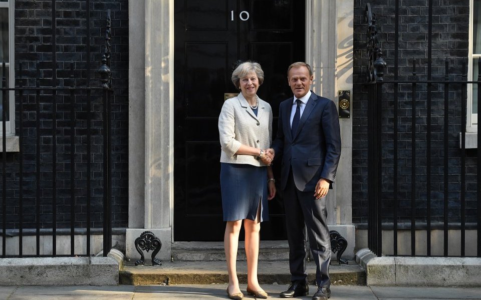 theresa may greets the president of the european council donald tusk